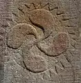 A lauburu on the baptismal font at the church of Knopp-Labach